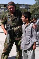 A member of the 3rd Battalion, The Princess of Wales's Royal Regiment, meets the locals in Afghanistan in 2003.