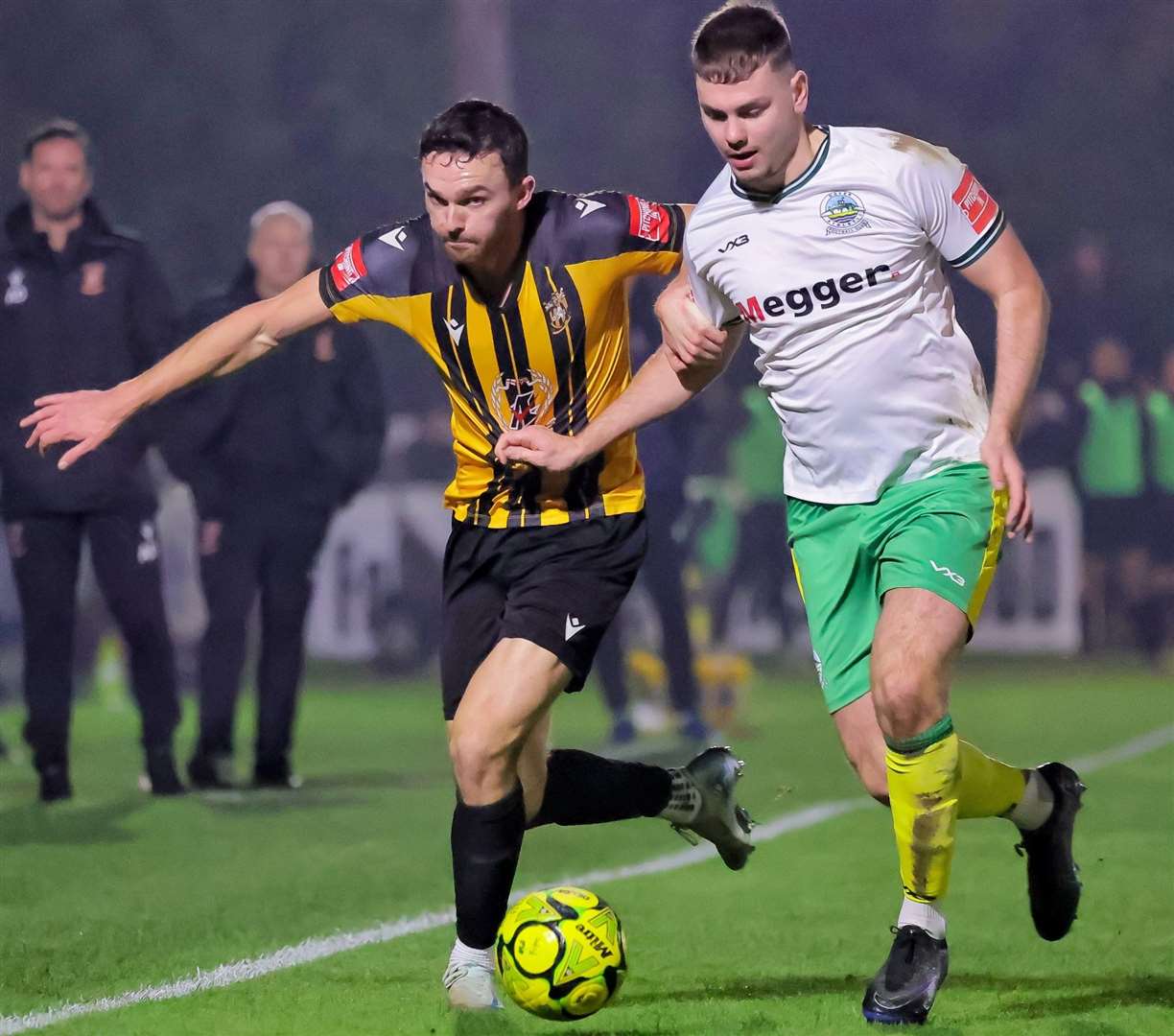 Folkestone forward Dan Smith battles for the ball with Dover defender Luca Cocoracchio during Whites’ 1-0 Isthmian Premier win on Tuesday night. Picture: Helen Cooper