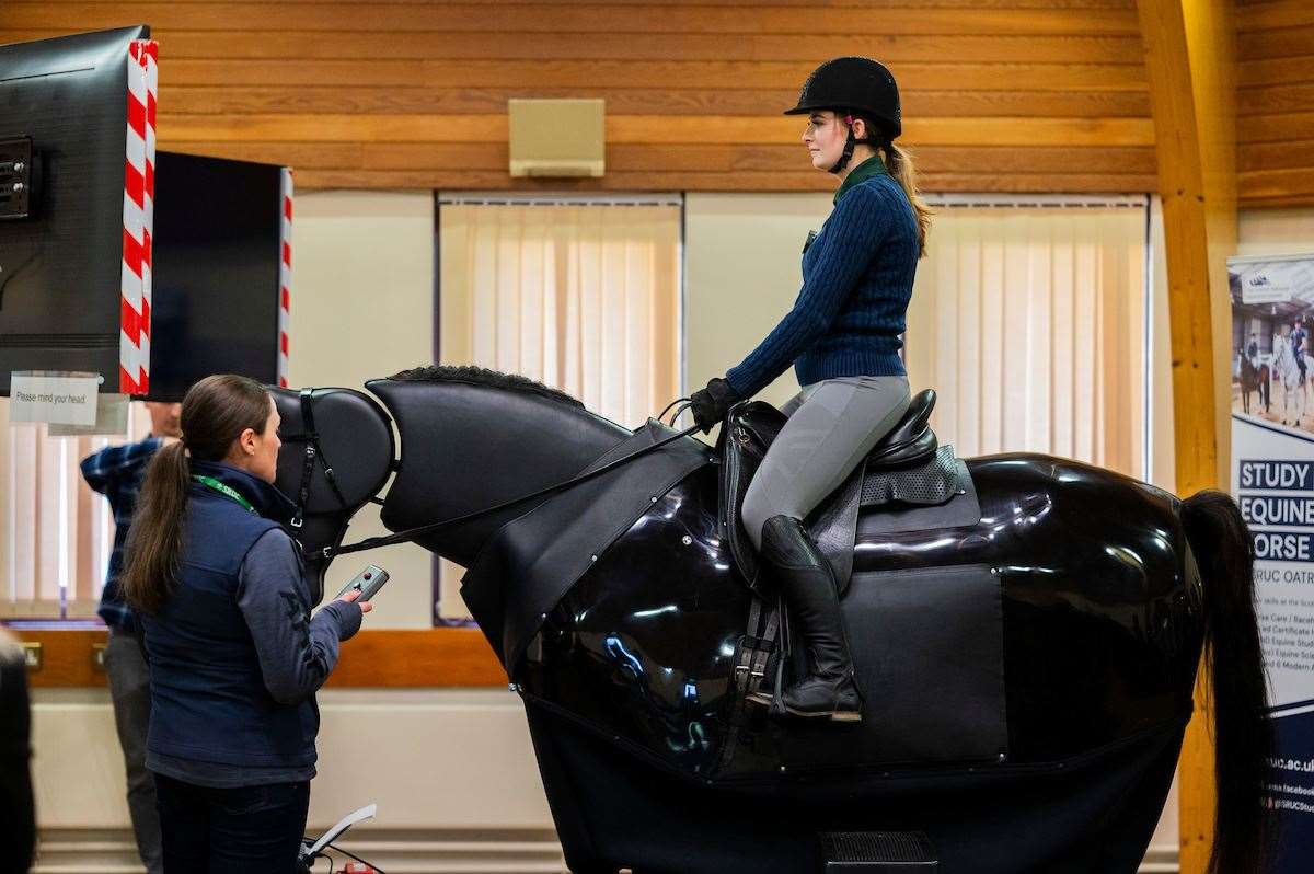 Student Erin Gillie has a ride on ‘RoboCob’ (Chris Watt Photography/PA)