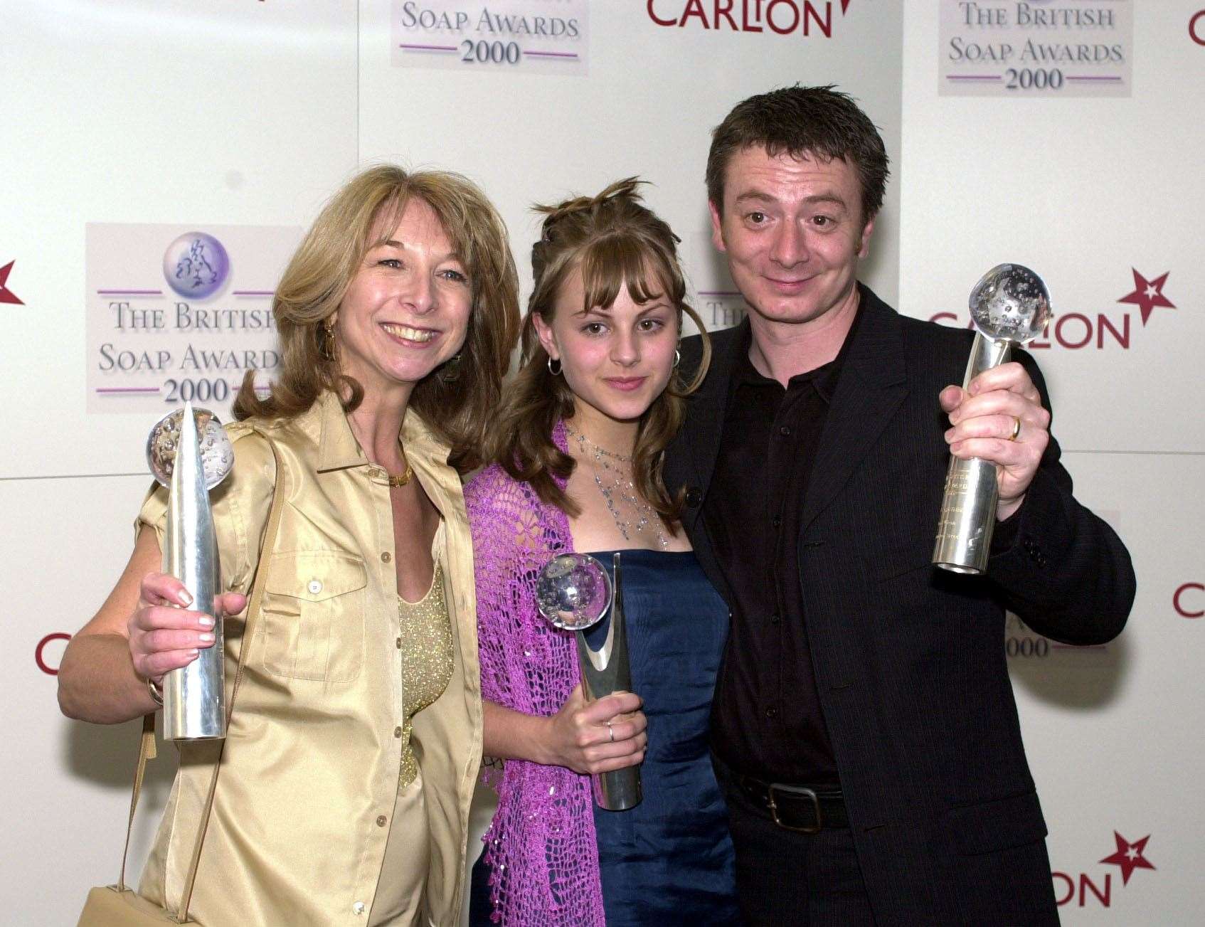 Sean Wilson with Helen Worth, who played his Coronation Street wife Gail, and Tina O’Brien, who played his stepdaughter Sarah, with their Best Storyline awards at the British Soap Awards 2000 (John Stillwell/PA)