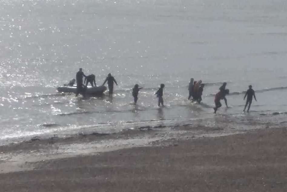 People coming ashore at Kingsdown after leaving a small boat in the water. Picture Christian Thrale