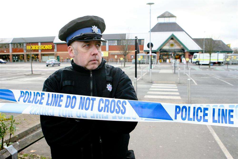 A policeman guards the crime scene