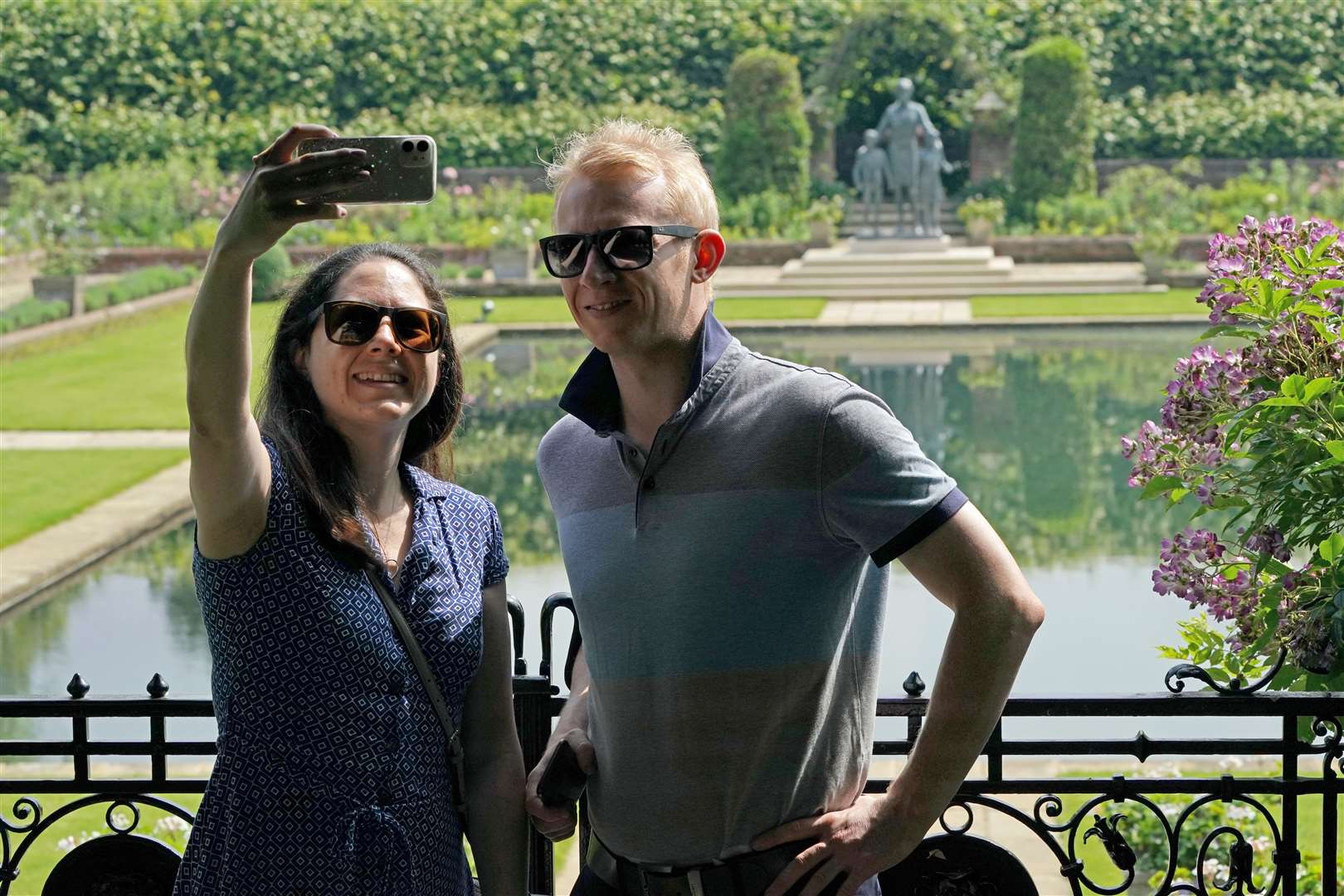 Members of the public take a selfie with the statue (Jonathan Brady/PA)