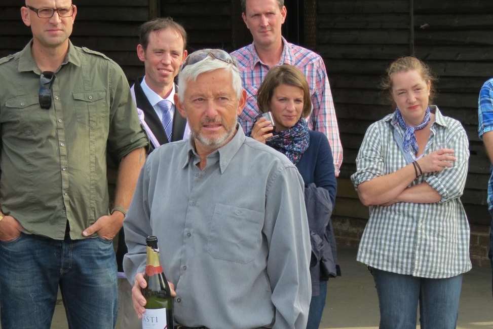 Robin Chapman (foreground) watches as a boat is named after himself