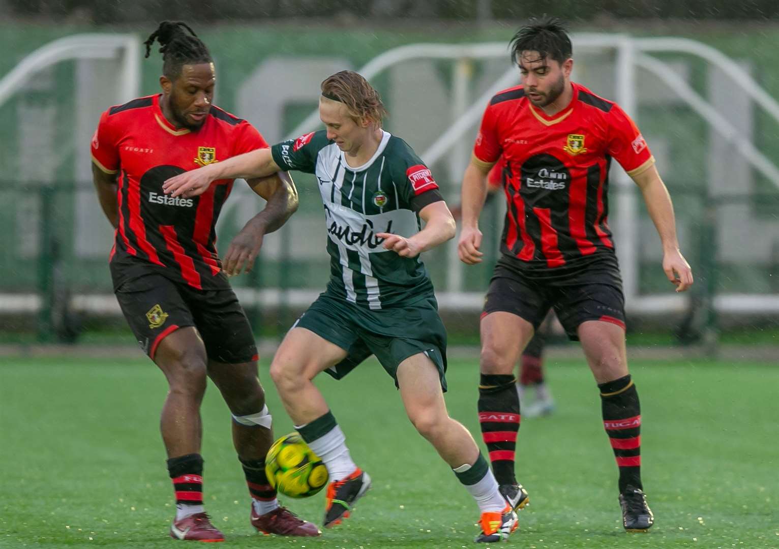 Sittingbourne duo Chris Arthur and Richie Hamill pay close attention to Ashford midfielder Mikey Berry on New Year's Day. Picture: Ian Scammell