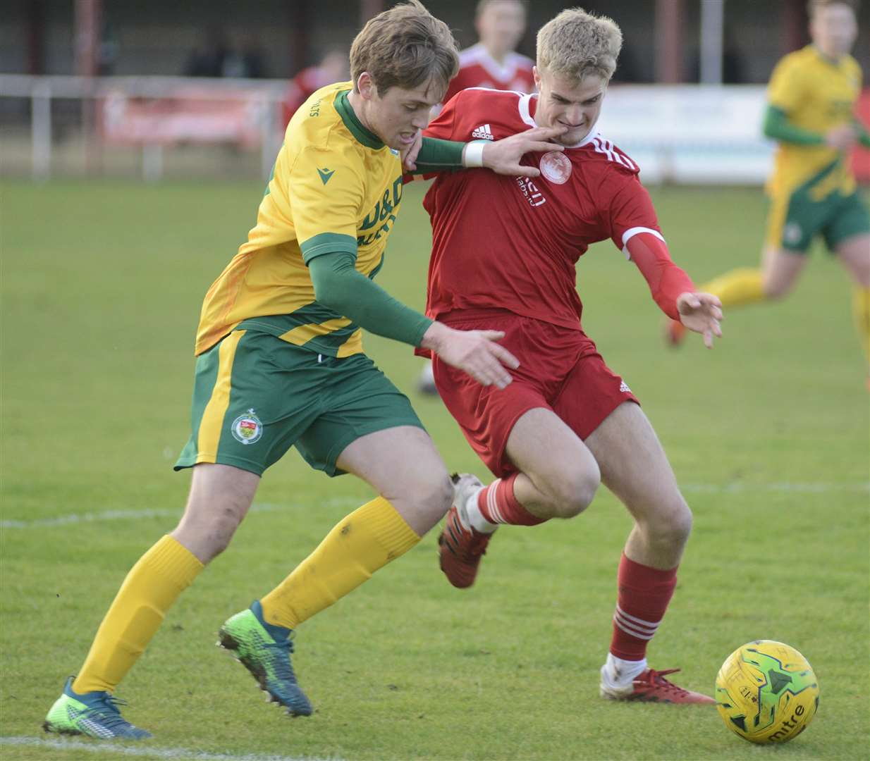 Ashford's Tom O'Connor, left, battles for possession against Hythe Picture: Paul Amos