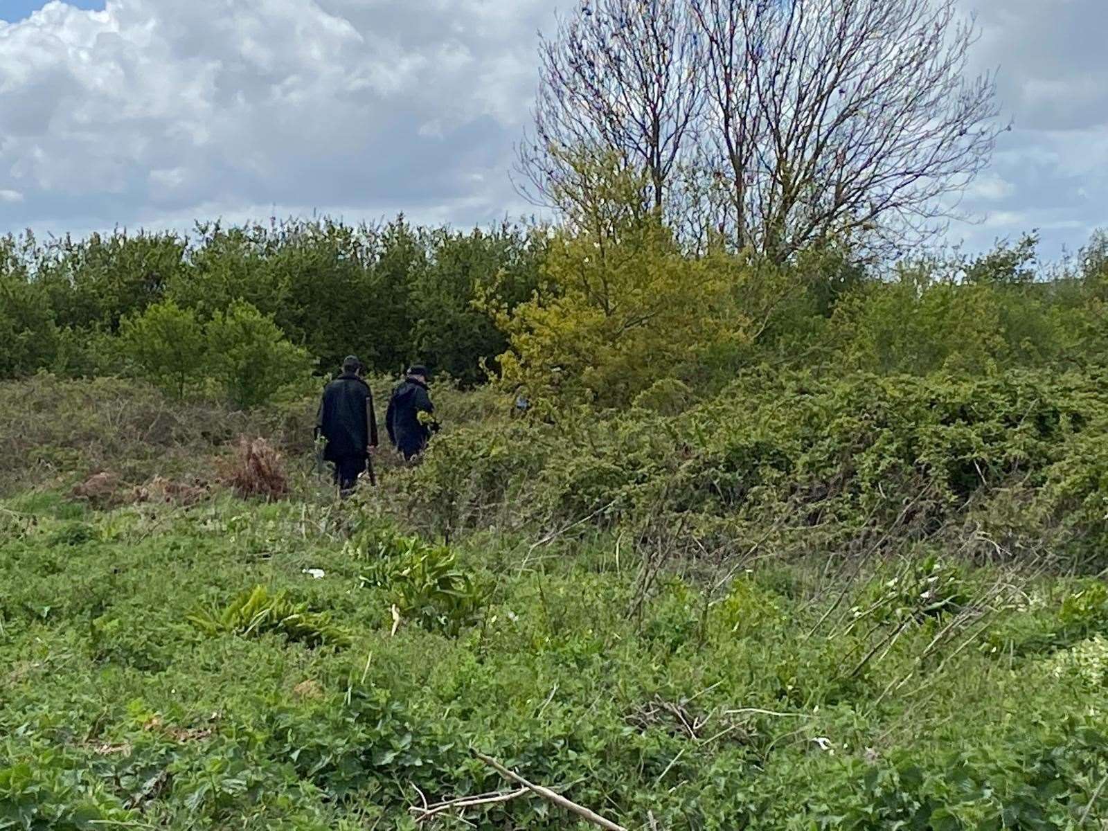 Police search waste land Picture: Barry Goodwin