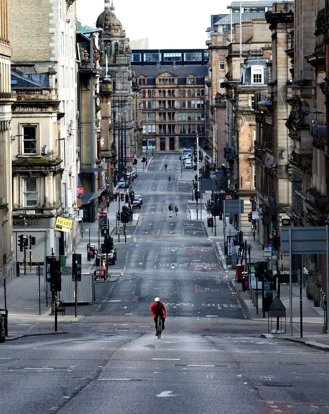 A cyclist makes his way up a quiet St Vincent Street in Glasgow as the UK entered lockdown in March to help curb the spread of the coronavirus (Andrew Milligan/PA)