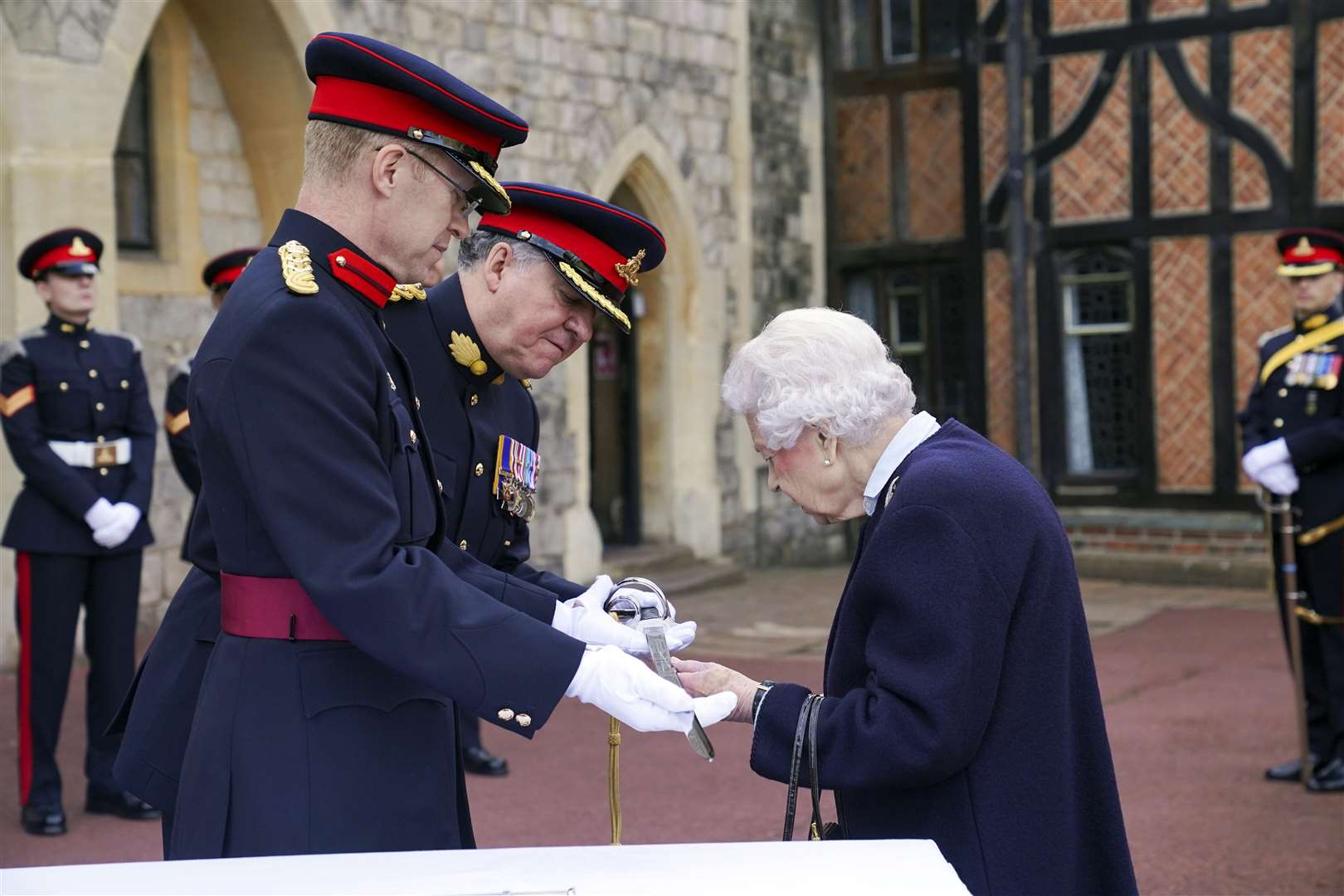 The Queen takes a closer look at the sword presented to the The Captain General’s Sword to the Royal Regiment of Canadian Artillery (Steve Parsons/PA)