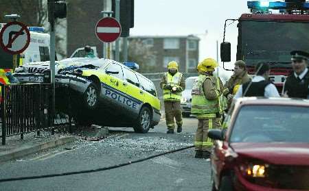 The police car ended up perched on top of railings. Picture: PHIL MEDGETT