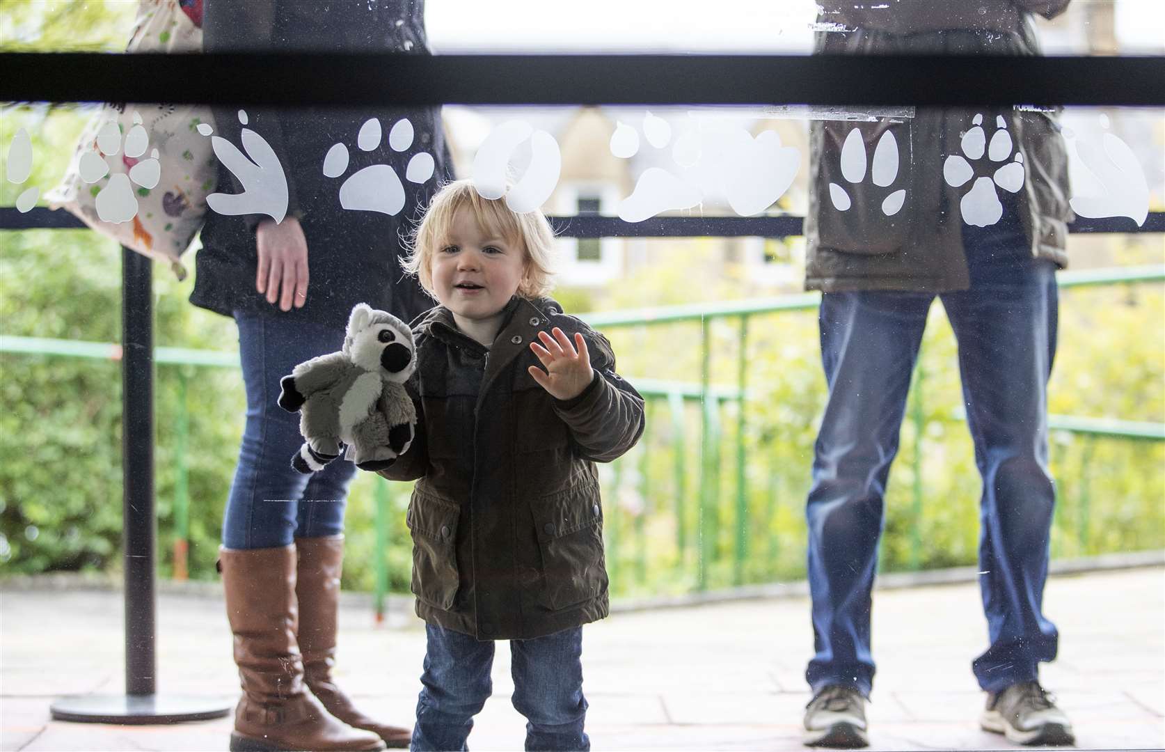 Two-year-old Murray Hunter and his toy lemur wait excitedly at the front of the queue (Jane Barlow/PA)