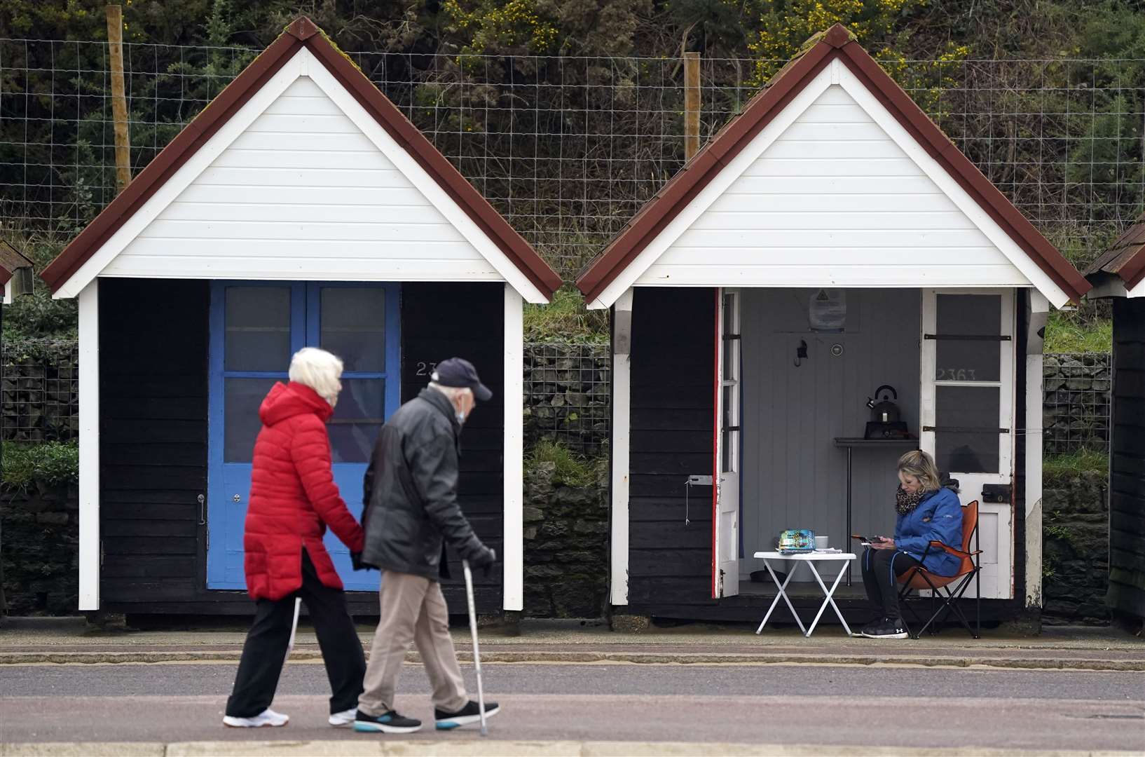 People walk along the sea front on Bournemouth beach in Dorset on a mild December day (Andrew Matthews/PA)