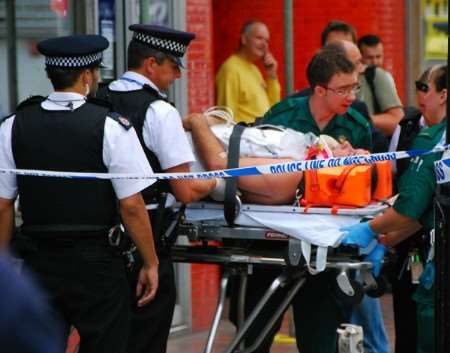 The injured officer is taken out of the building on a stretcher. Pictures: Nick Evans