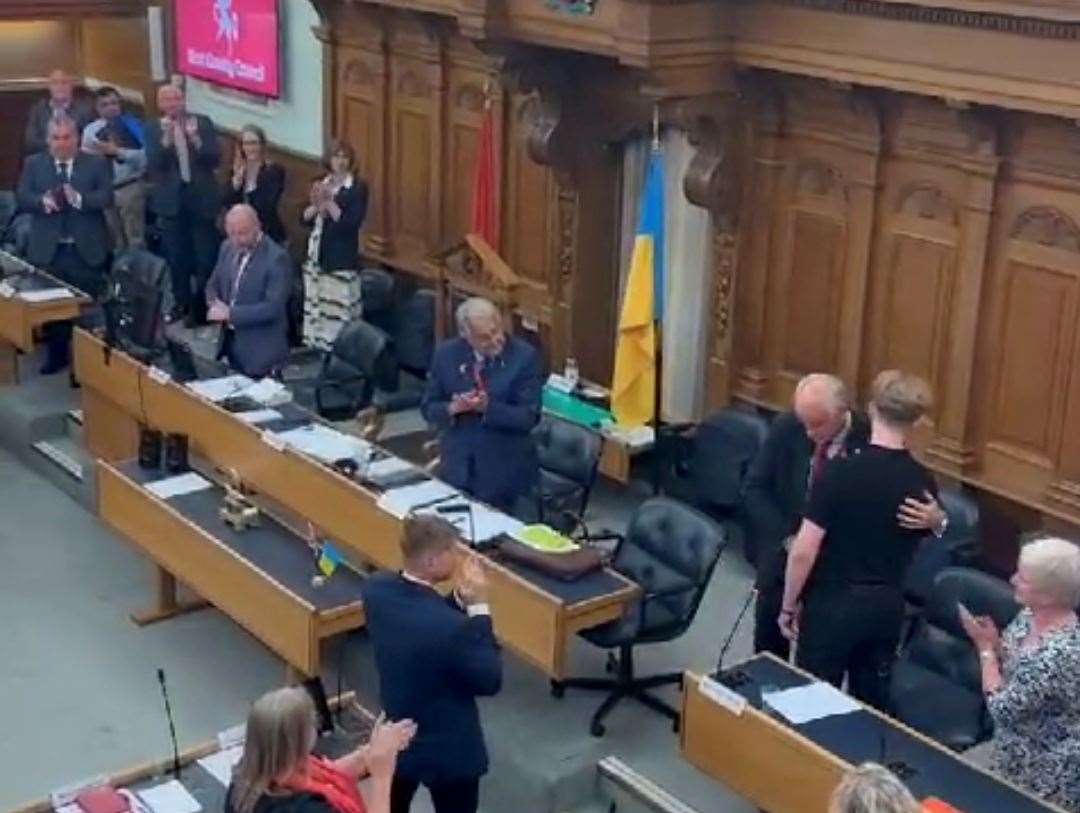 Vlad Saovoi hugged by Cllr Bryan Sweetland after the young Ukrainian's moving speech to KCC