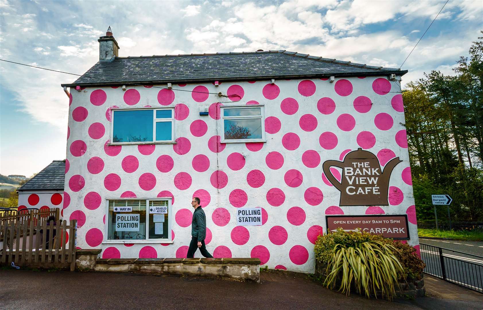 A woman and her dog outside the Bank View Cafe polling station in Sheffield (Danny Lawson/PA)