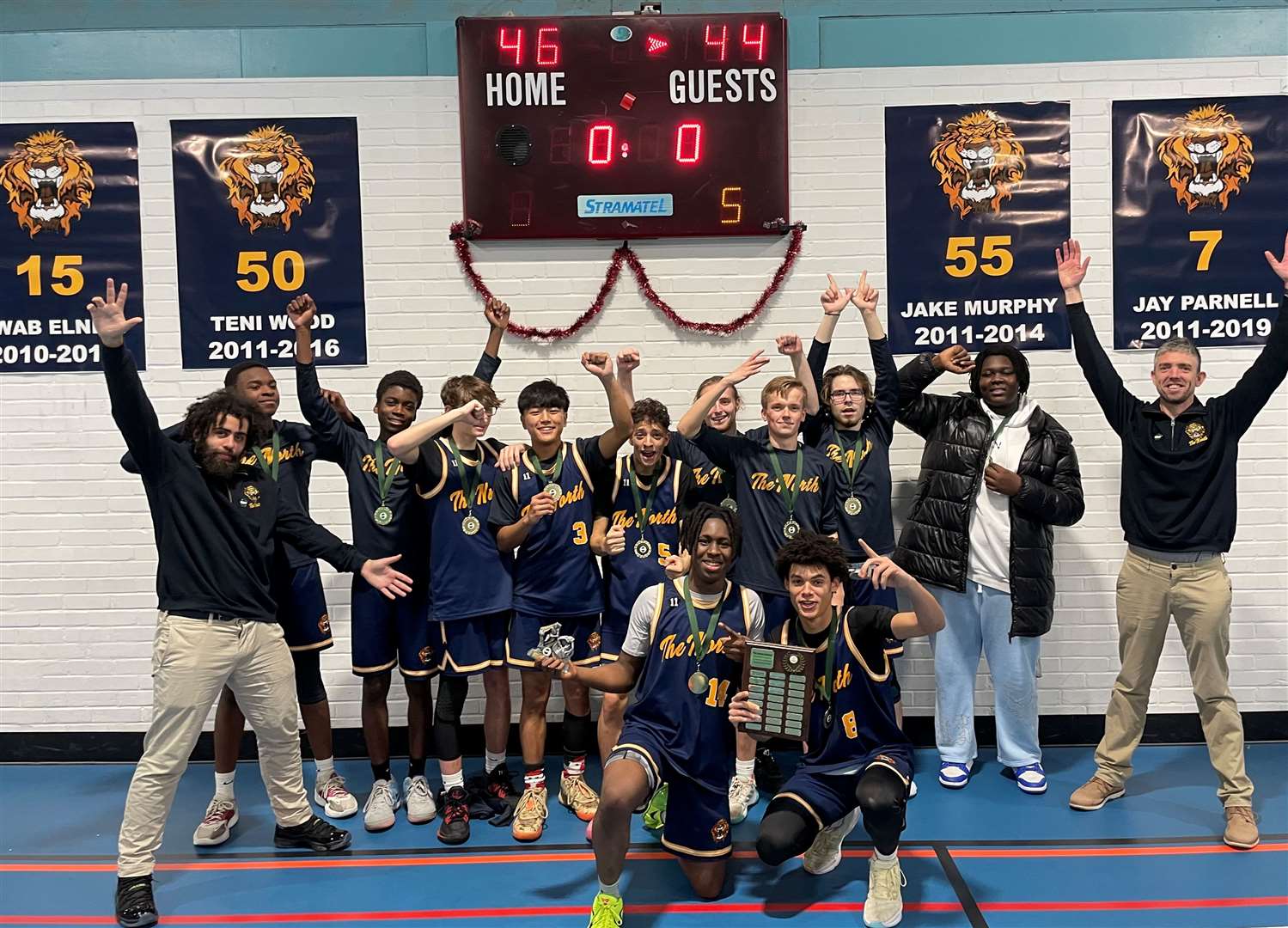 The North School Lions celebrate victory over Sevenoaks School in their Christmas Invitational Basketball tournament