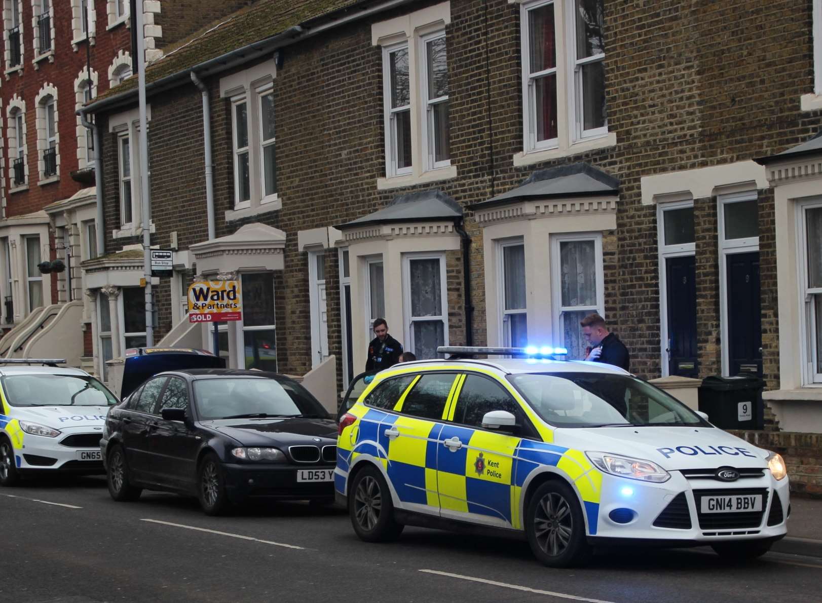 Stopped: Police hem in a BMW in Trinity Road, Sheerness