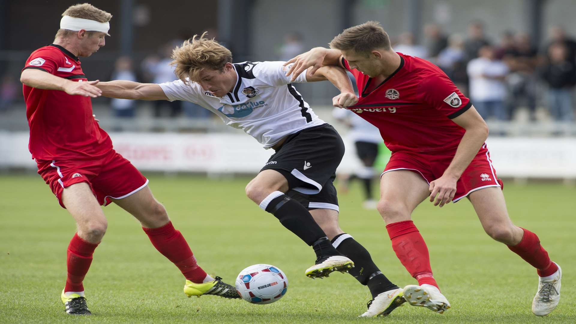 Dartford striker Tom Bradbrook takes on two Truro defenders Picture: Andy Payton