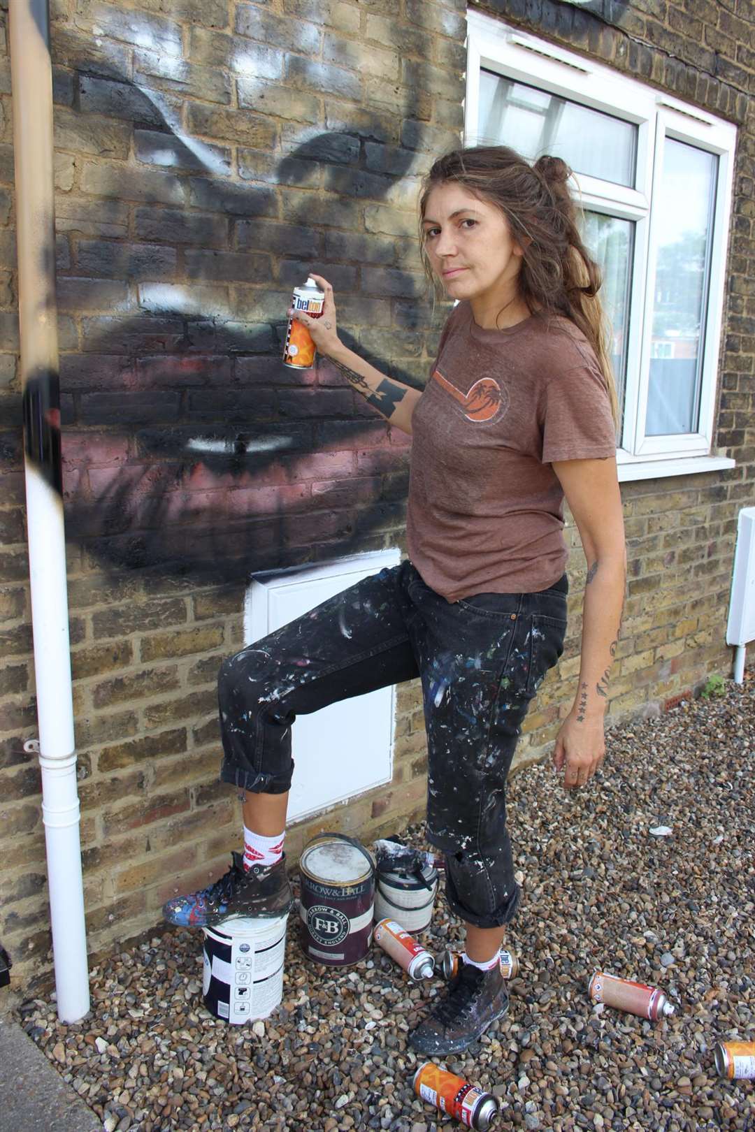 Muralist Jules Muck from the USA at work turning Denise Kerry's home in Medway Road, Sheerness, Sheppey into Harry Potter's Hogwarts (3656833)