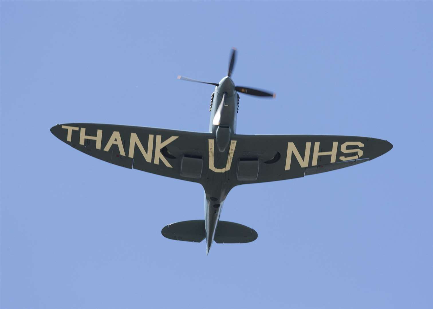 The specially-painted spitfire passing over Kent and Canterbury Hospital today. Photo: Tim Gutsell