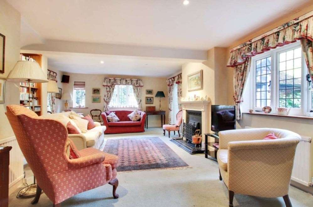 The cosy sitting room lets in plenty of natural light from the stunning grounds. Picture: Savills
