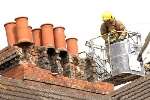 A firefighter assesses the damage to a roof in Folkestone. Picture: GARY BROWNE