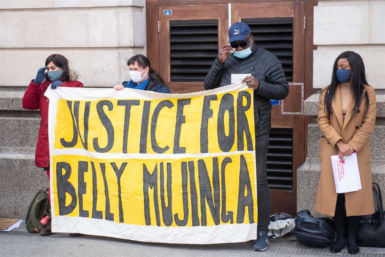 Belly Mujinga’s husband, Lusamba Katalay (second from right), joins activists at a vigil to mark the first anniversary of her death (Dominic Lipinski/PA)