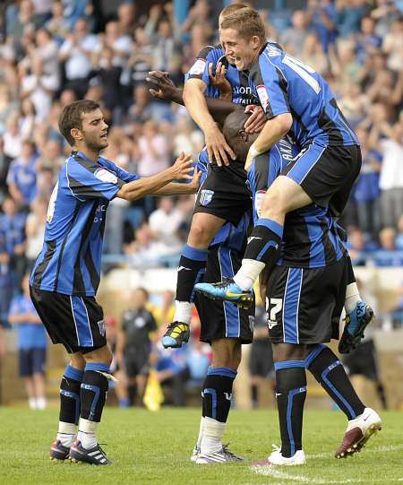 Gills players celebrate Adebayo Akinfenwa's goal on the opening day of the season