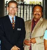 Jim Barker-McCardle, Deputy Chief Constable of Kent (left), receives the award from Keith Jarrett of the Black Police Association