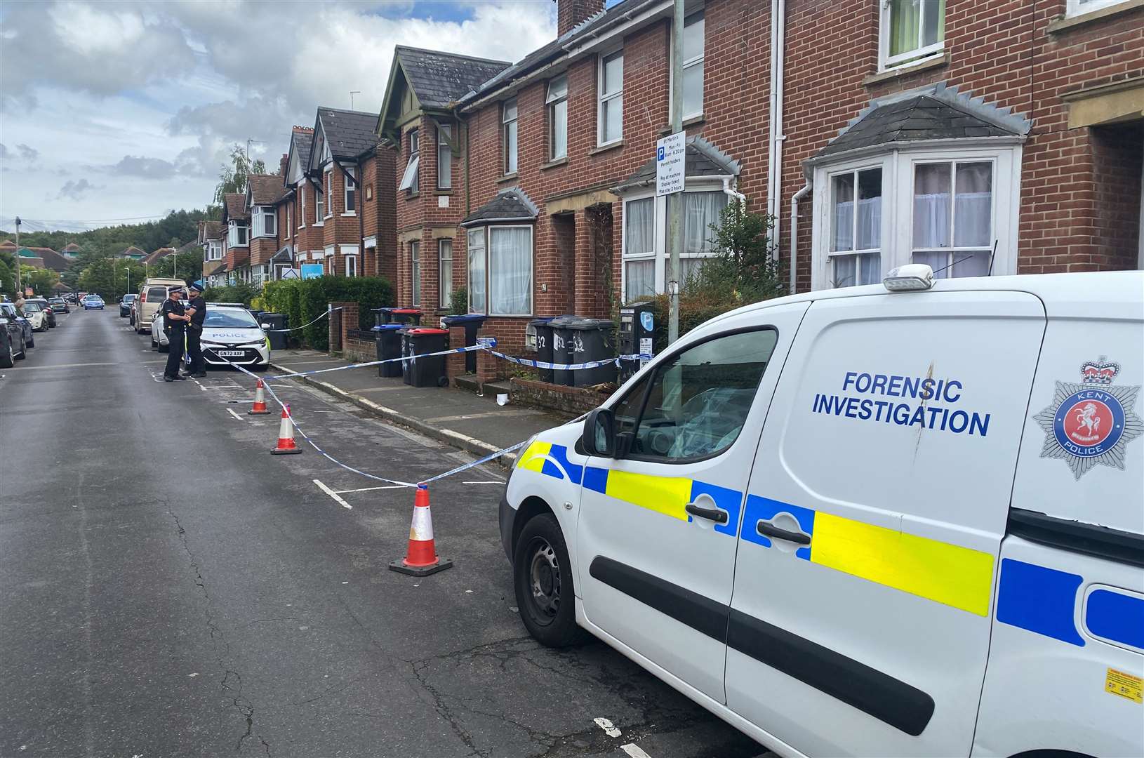 Police and forensics officers in St Martin's Road, Canterbury, following the discovery of human remains