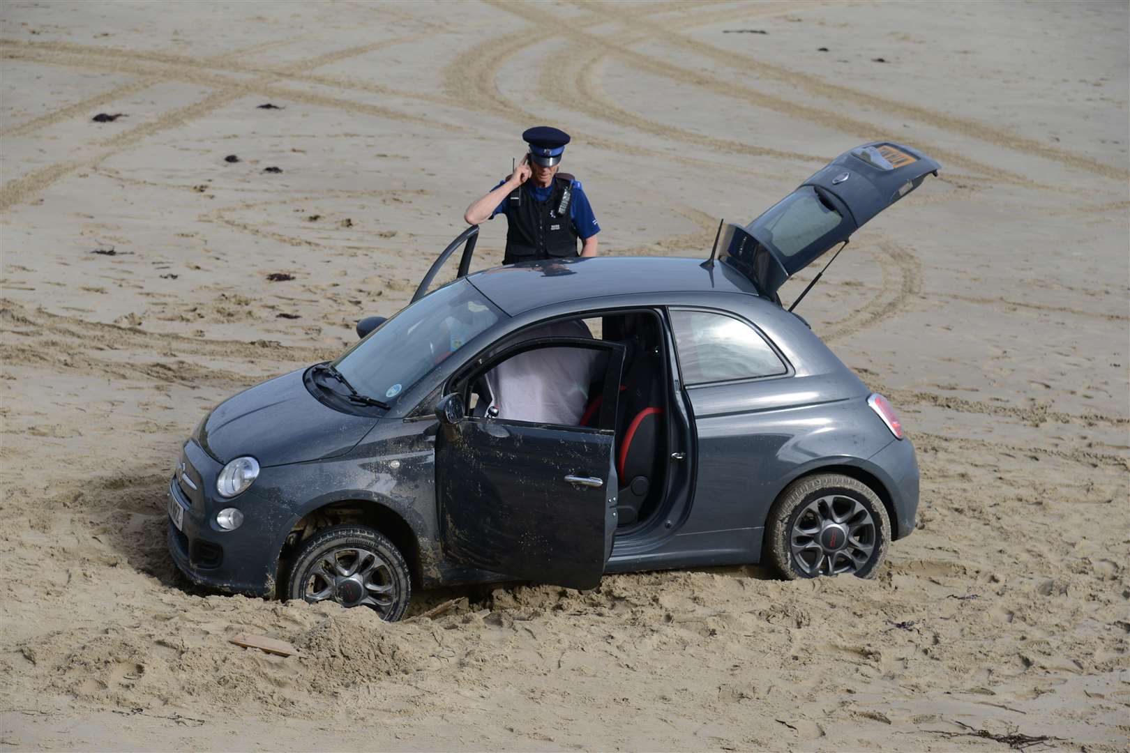 A car stuck on Sunny Sands beach in Folkestone. Picture: Gary Browne