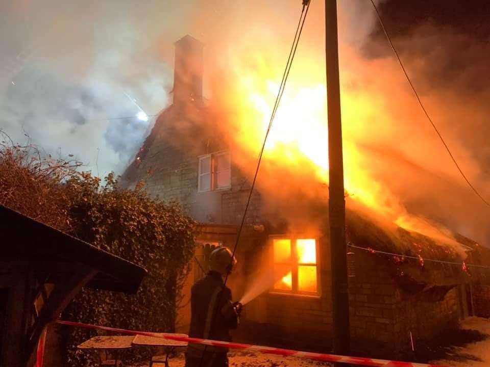 Firefighters tackle the blaze at a thatched cottage in Poxwell. Picture Dorset and Wiltshire Fire Service