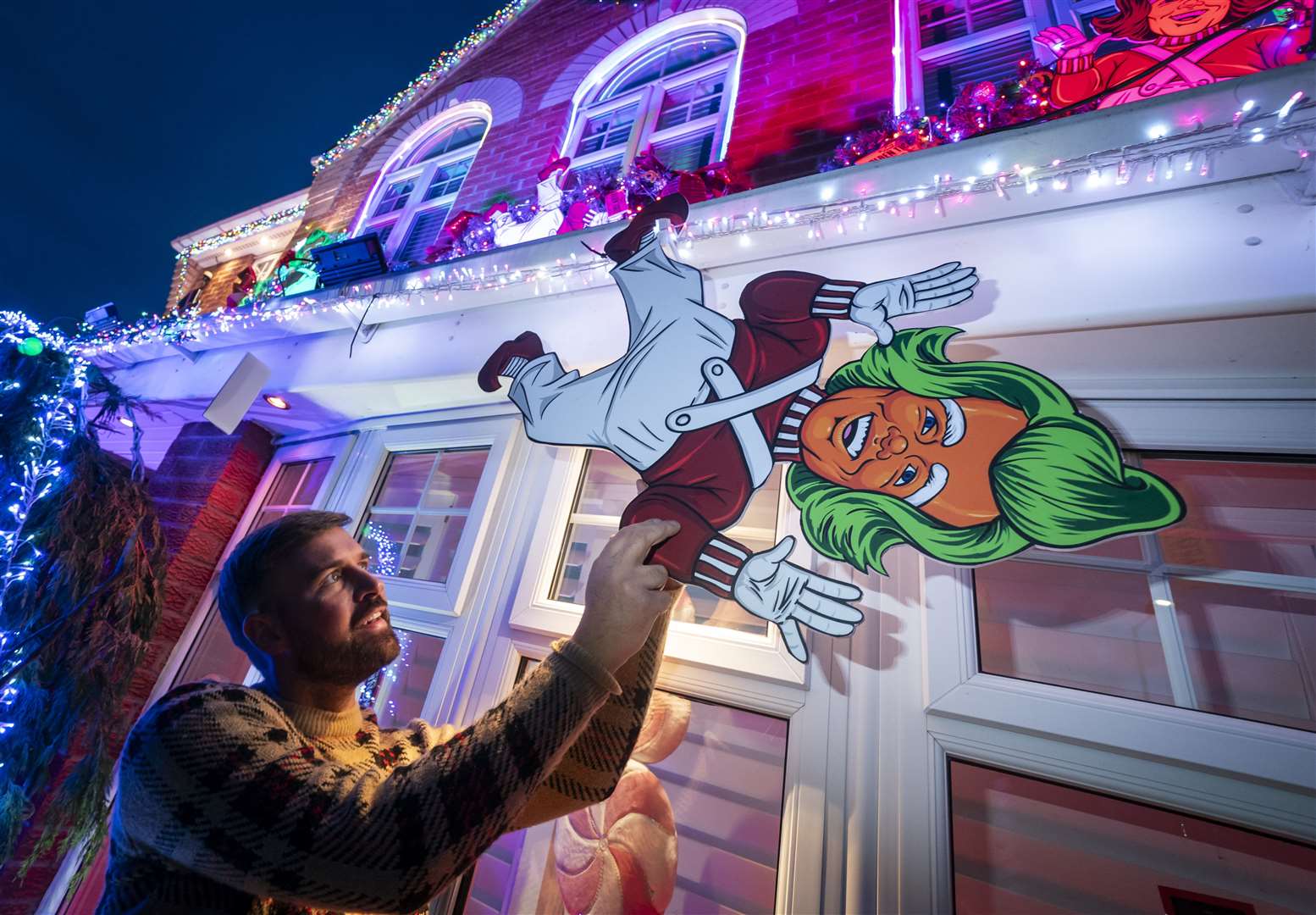 Michael Fenning puts the finish touches to his Wonka-themed home (Danny Lawson/PA)