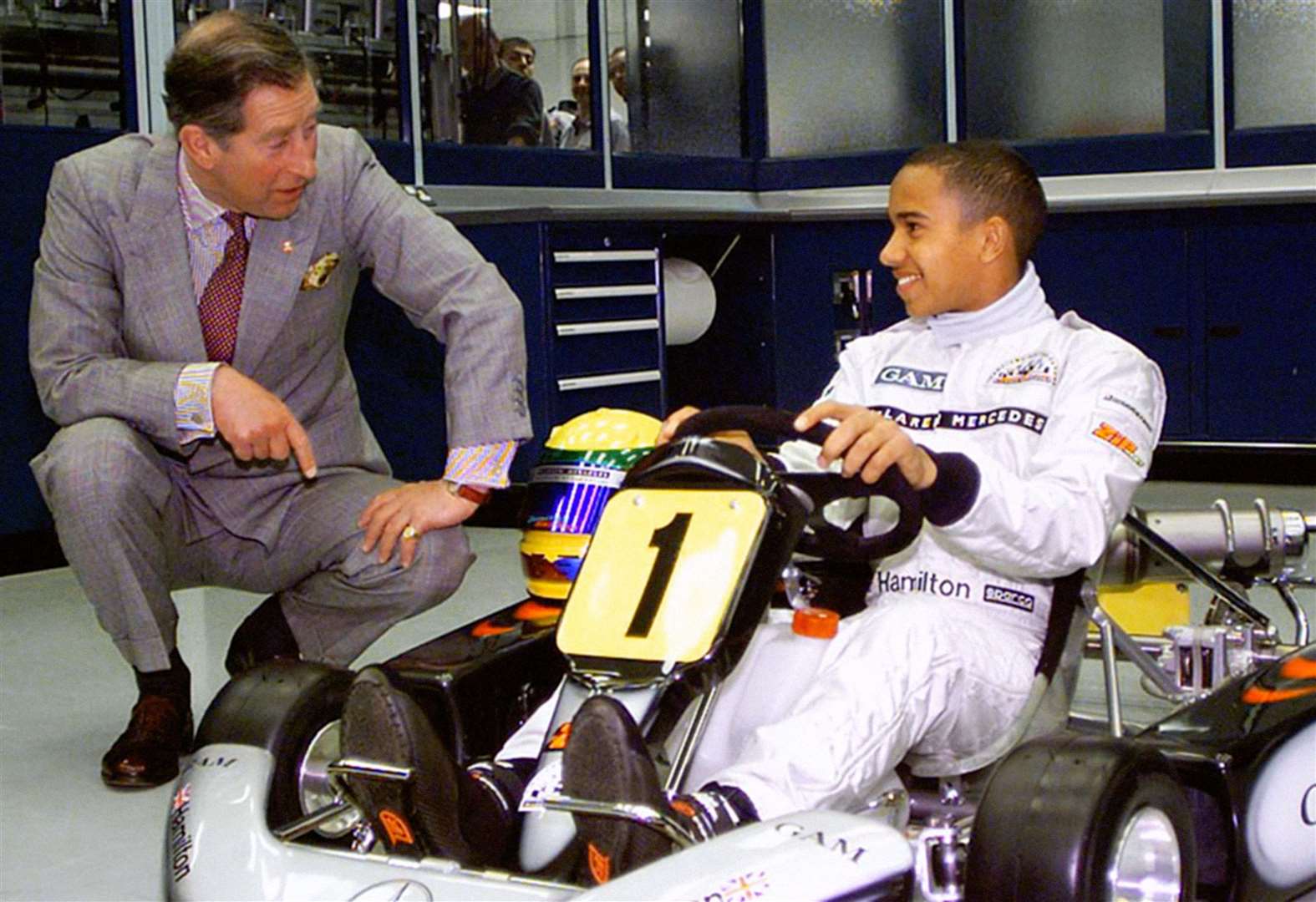 The Prince of Wales pictured with a 14-year-old Lewis Hamilton during the 1990s when he was being sponsored by McLaren’s driver support programme (Kieran Doherty/PA)