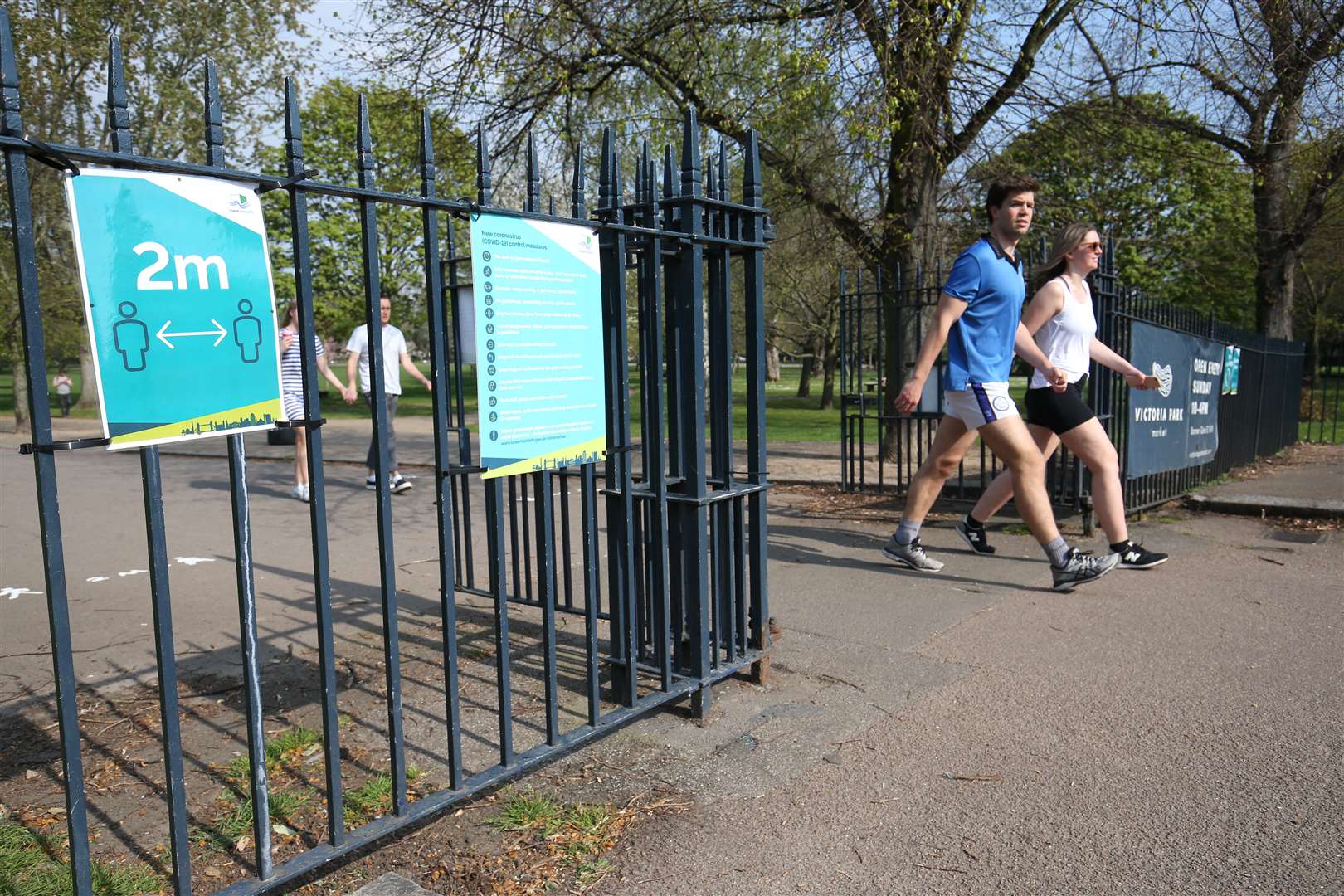 Signs on the gates reminding people to ‘social-distance’ at Victoria Park in east London (Jonathan Brady/PA)