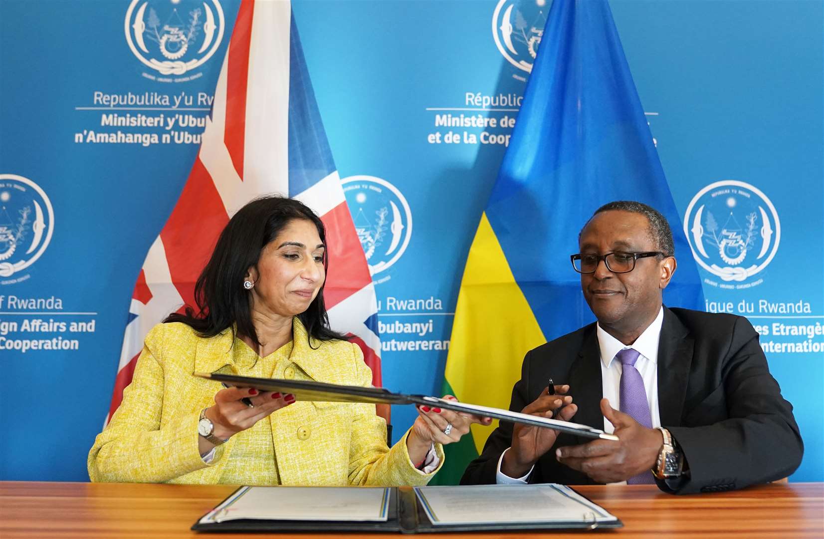 Home Secretary Suella Braverman and Rwandan minister for foreign affairs and international co-operation, Vincent Biruta sign an enhanced partnership deal in Kigali in March (PA)