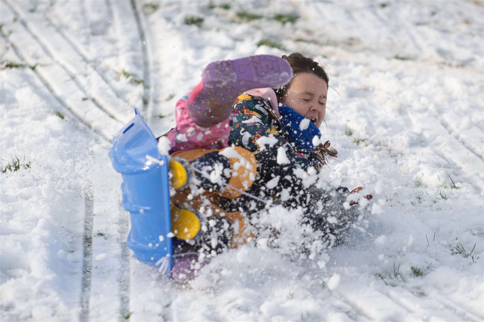 Maddie, seven, enjoys playing in the snow in Newcastle-under-Lyme (Joe Giddens/PA)