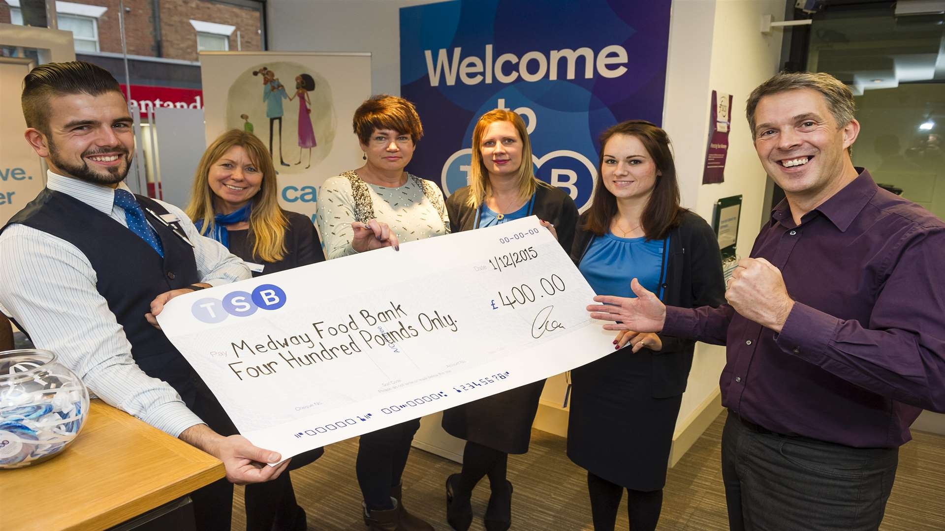 Staff at TSB in Chatham present Ian Childs (right) from Medway Foodbank with a cheque for £400.