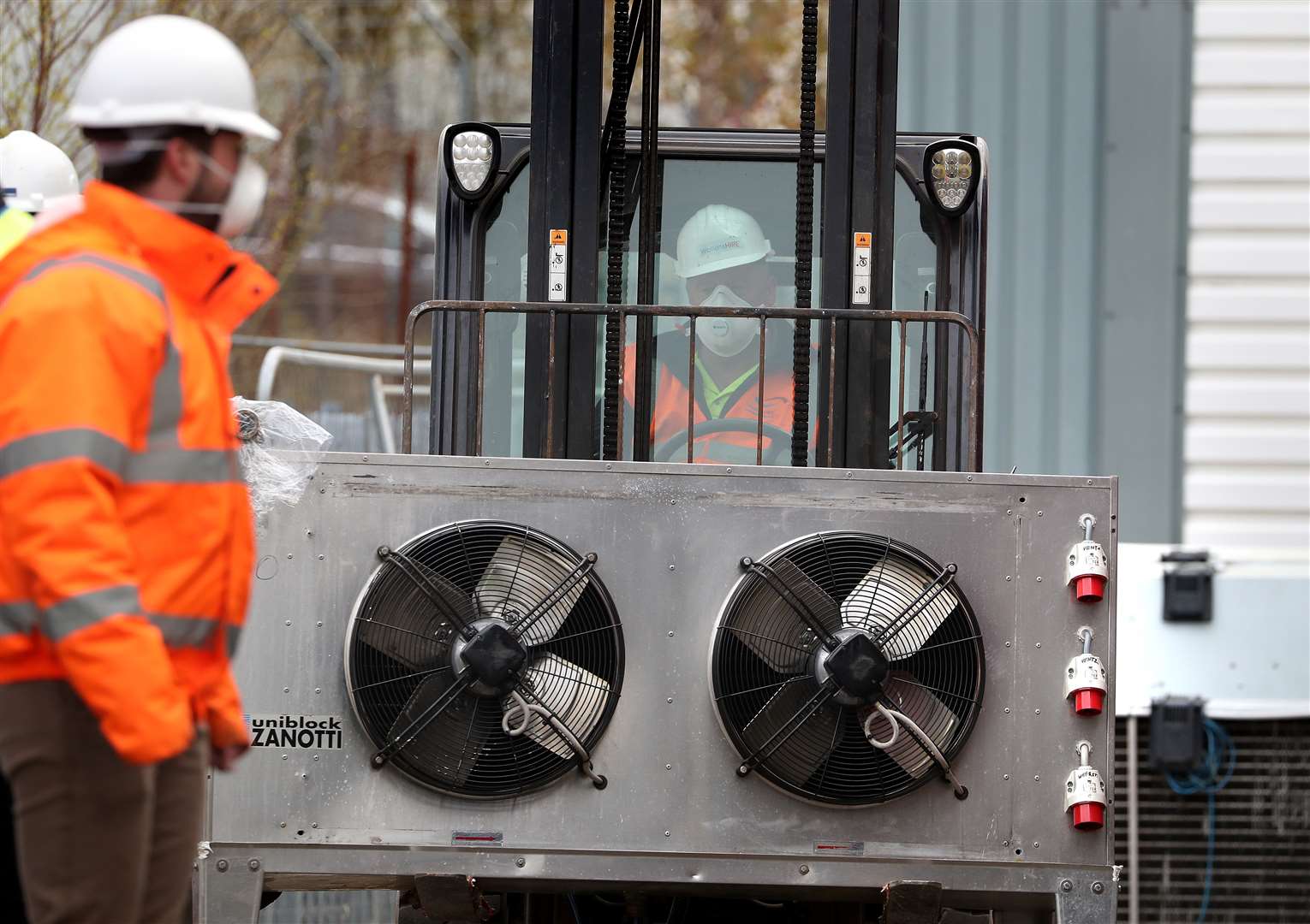 A refrigeration unit is moved into the site (Andrew Milligan/PA)