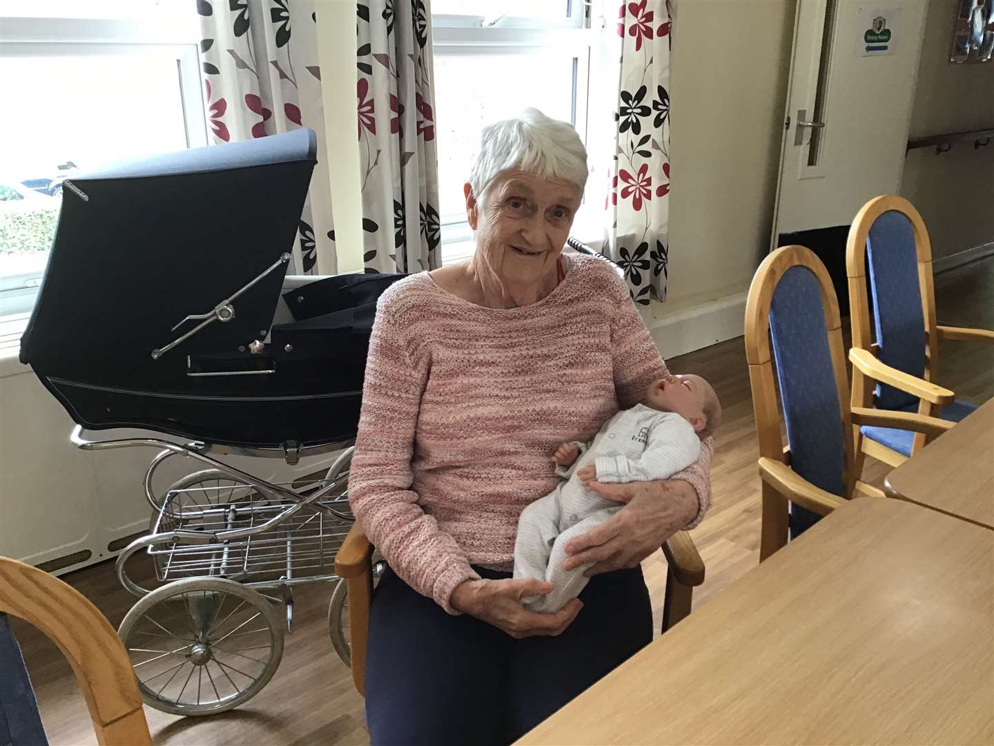 Marylyn enjoys pushing the doll around in the stroller. Picture: Rapport Housing & Care