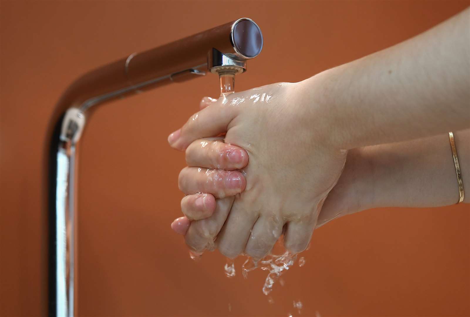 A person washes their hands under a tap (Philip Toscano/PA)