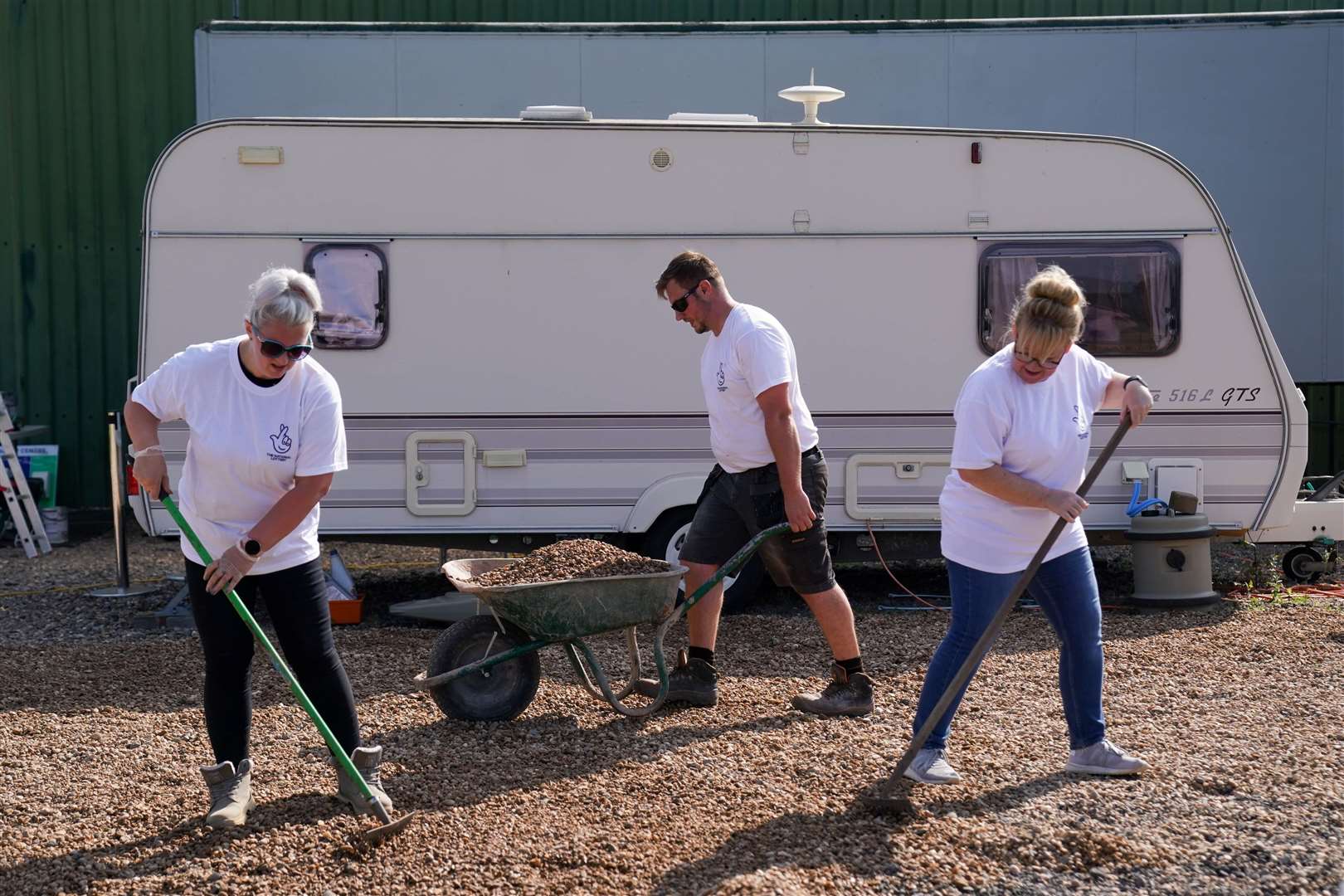 A group of National Lottery winners working at the site (Jacob King/PA)