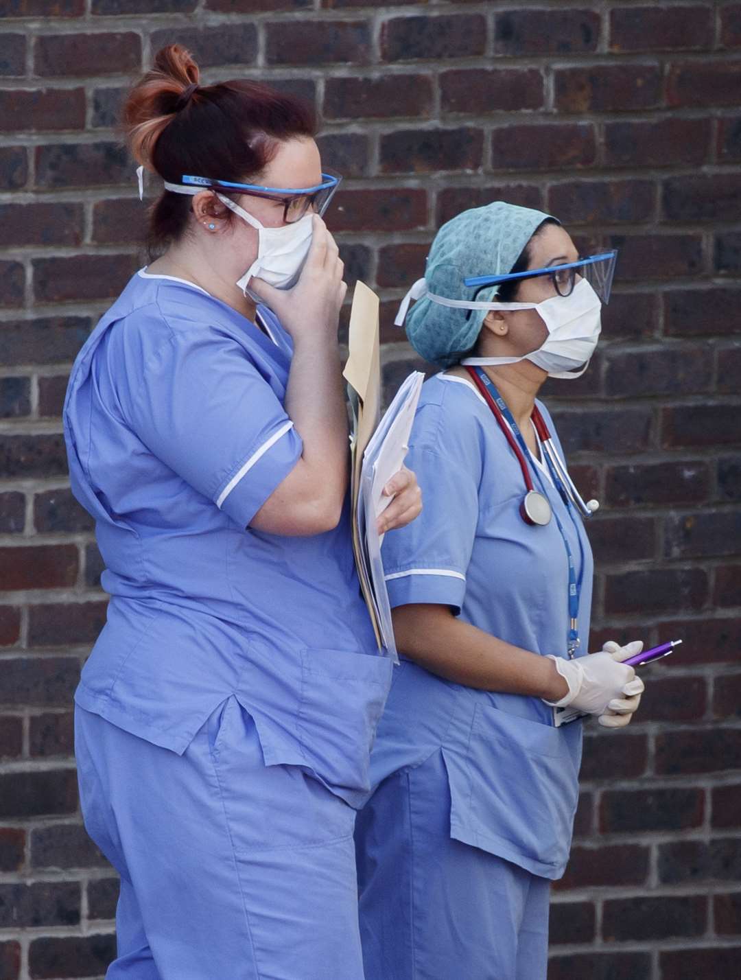 Hospital staff wear face masks outside Doncaster Royal Infirmary (Danny Lawson/PA)