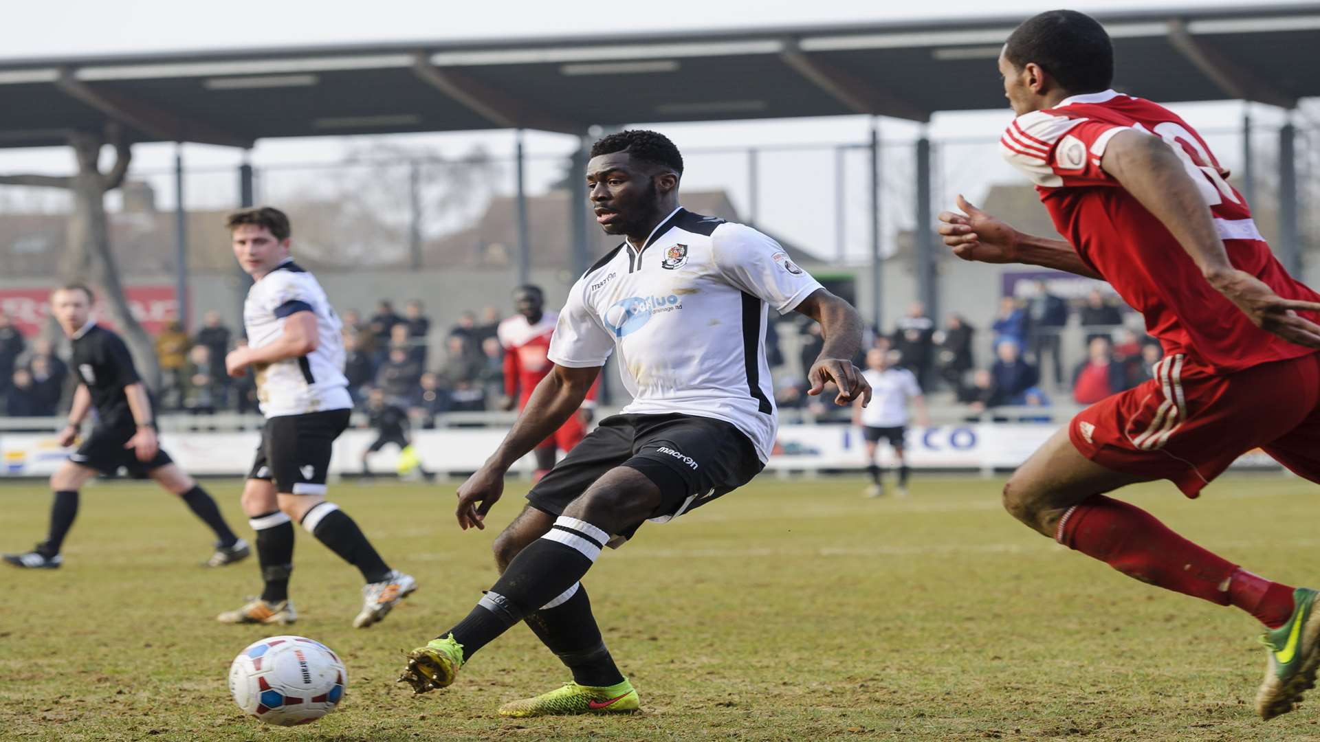 Mark Onyemah plays the ball under pressure from Whitehawk striker Danny Mills Picture: Andy Payton