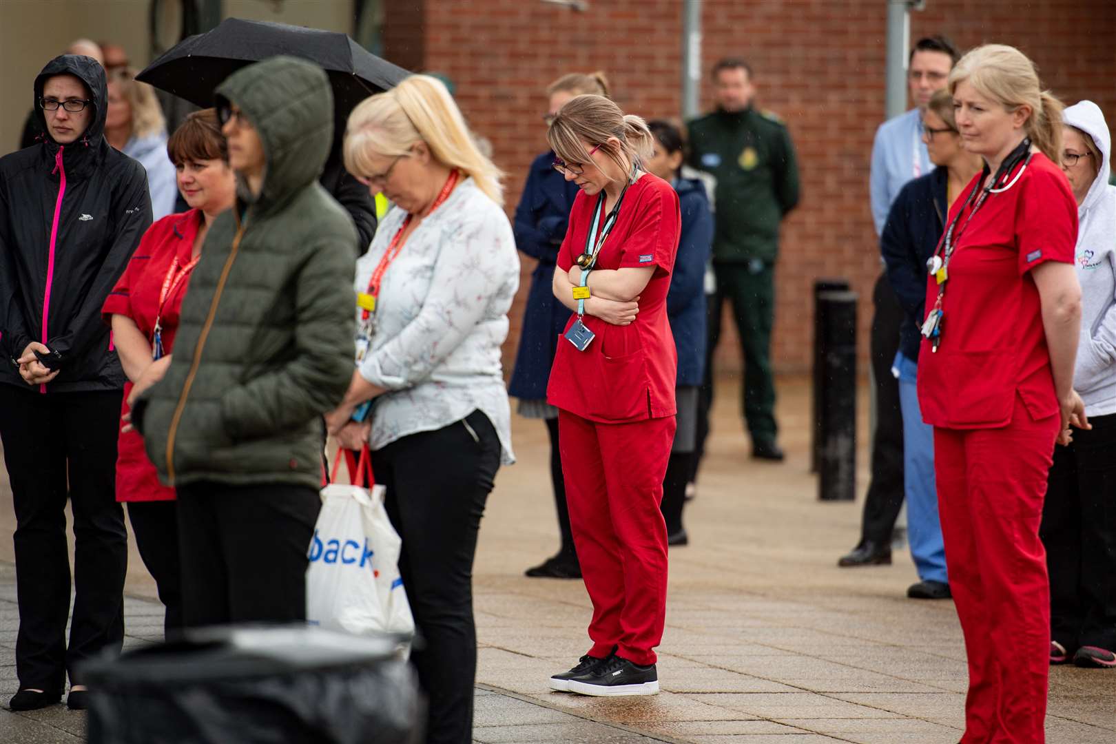 Staff members fell silent outside the Royal Derby Hospital (Jacob King/PA)