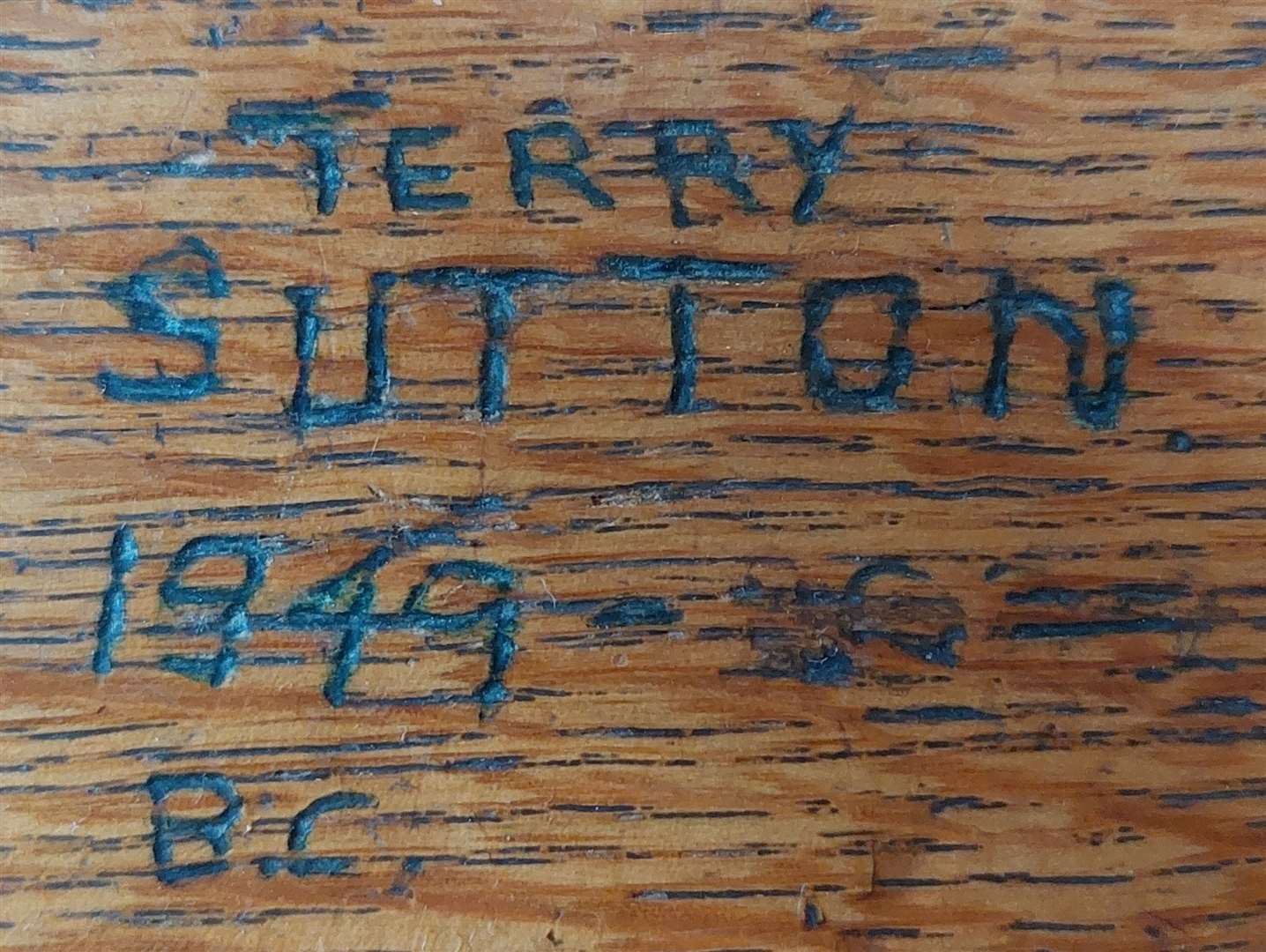 Local journalism legend Terry Sutton was one of generations of reporters carving their names on the court press bench at the Maison Dieu. This writing tells the year he started his career. Picture: Maison Dieu/Dover District Council