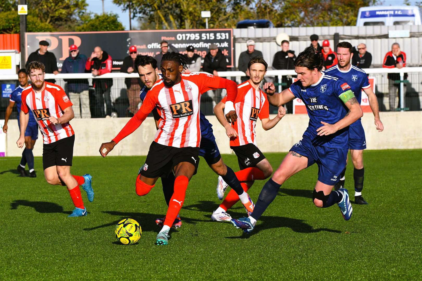 Sheppey's Gil Carvalho is closed down by Margate skipper Harry Hudson Picture: Marc Richards