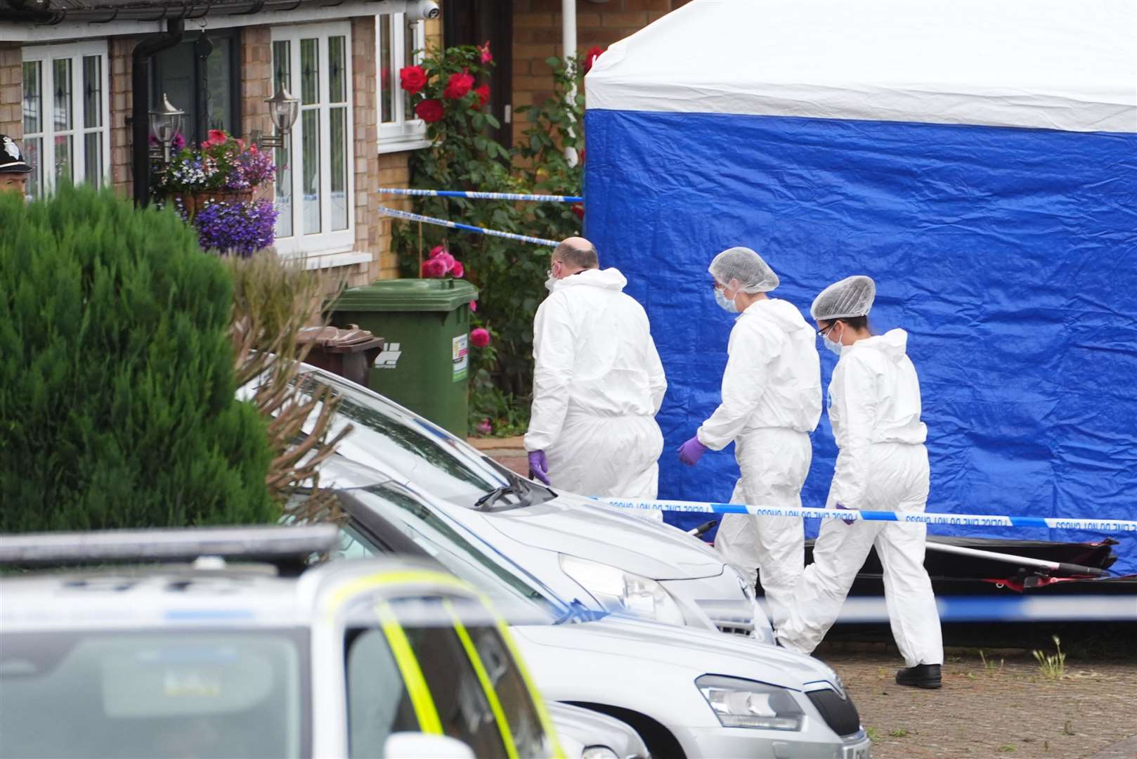 Forensic officers at the scene in Ashlyn Close, Bushey, Hertfordshire (James Manning/PA)