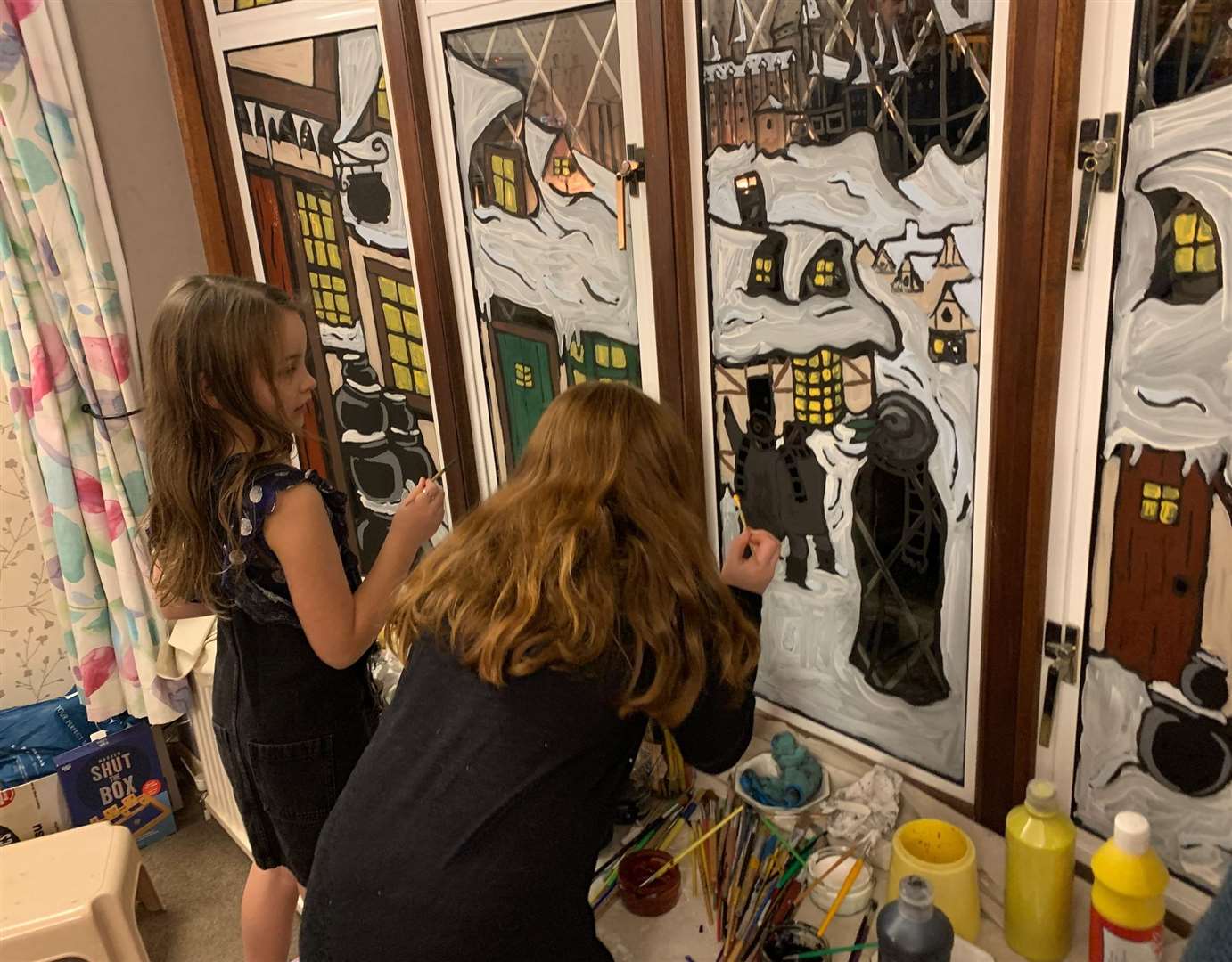 The future generation of the family, grandchildren Evelyn King and Megan Phillips painting the windows this year. Picture: Janita King