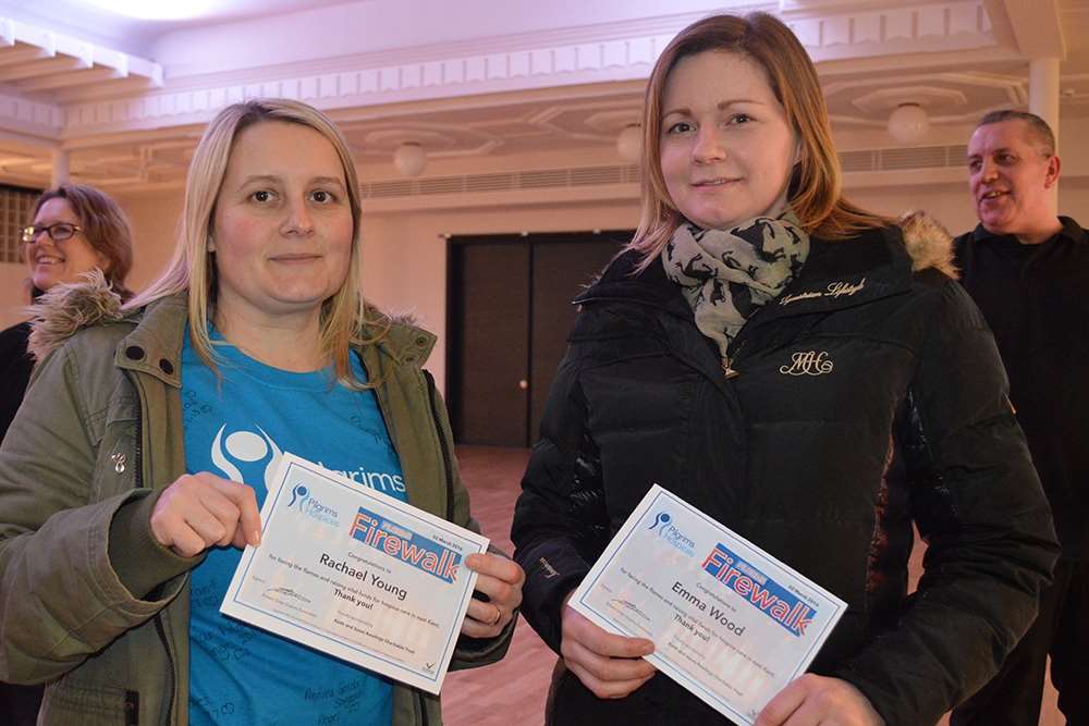 Firewalkers Rachael Young and Emma Wood collect their thank-you certificates